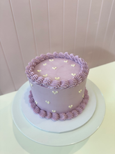Load image into Gallery viewer, Mini round cake decorated with dozens of small colourful heart designs lavendar

